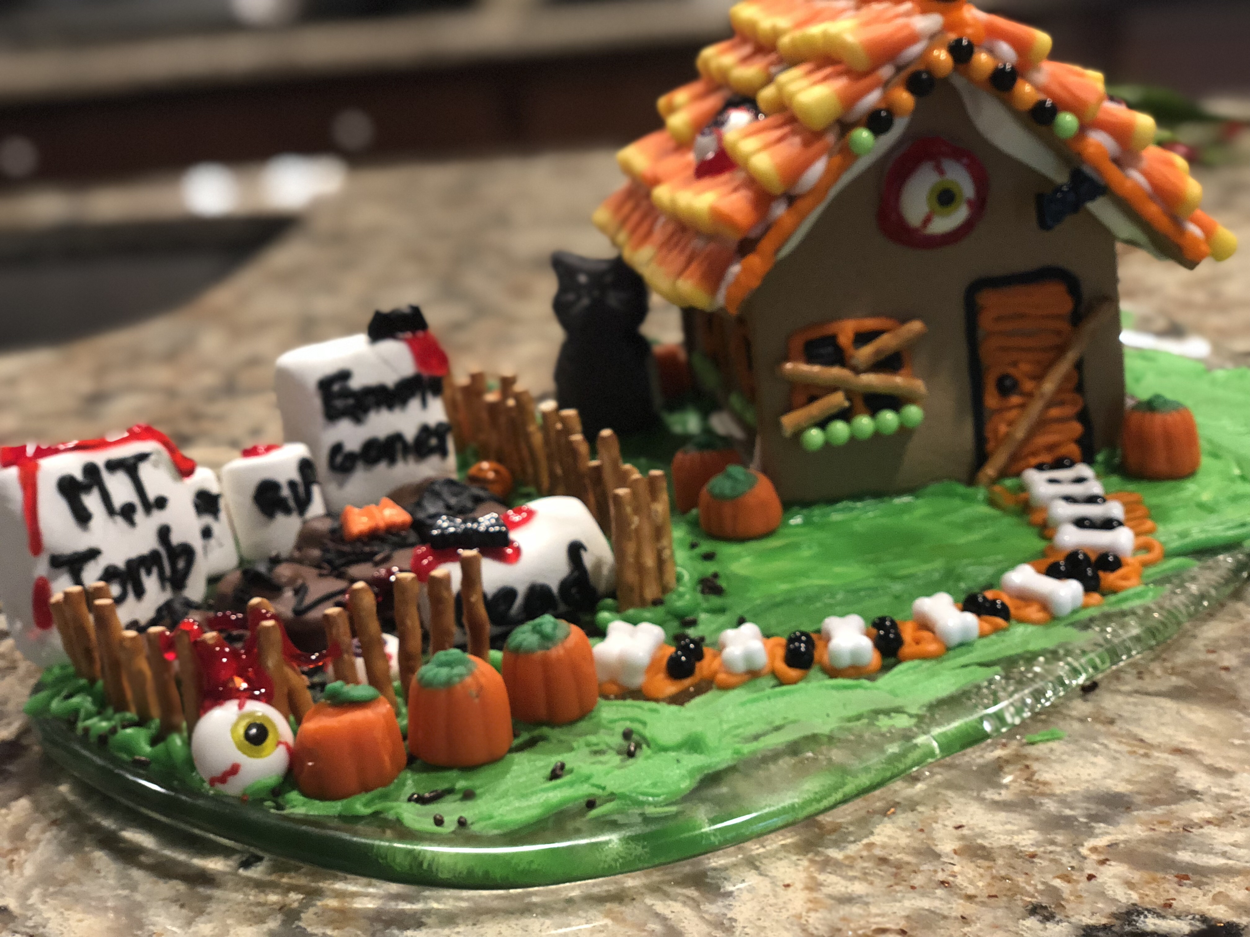 A well decorated haunted gingerbread house for a Halloween candy dish and decoration